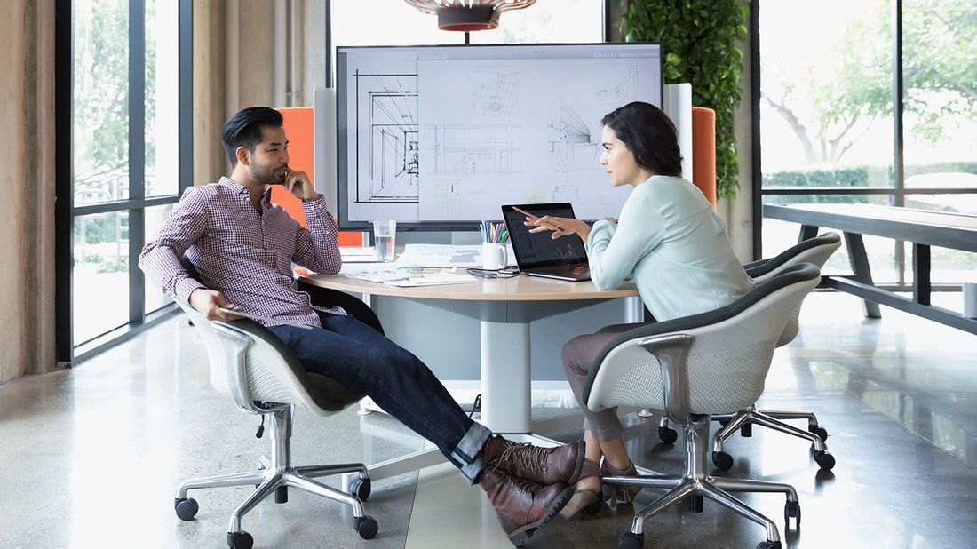 Coworkers discussing the types of insurance that can protect a business