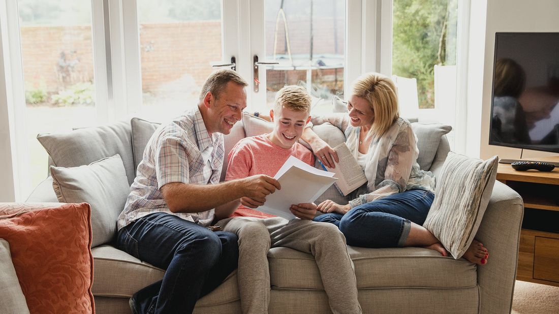 Family sitting on a coach reviewing steps to take before your child turns 18.