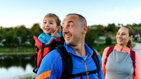 Family hiking near a lake.