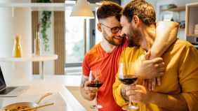 A couple enjoys time together in their kitchen 
