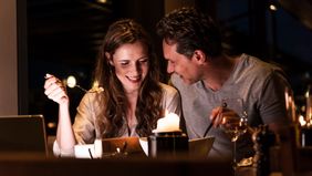 Couple sitting and smiling next to each other