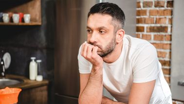Man in kitchen wondering what to do when you lose your job