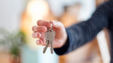 Man holding new house keys after getting mortgage while unemployed
