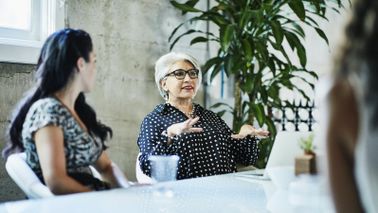 Woman building a multifaceted plan for retirement with her team of advisors.