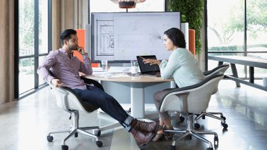 Coworkers discussing the types of insurance that can protect a business 