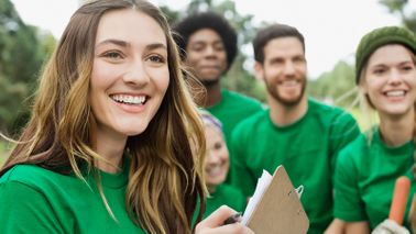 Evaluate a charity before giving volunteers smiling