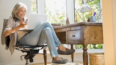 Woman on her computer checking the social security retirement age