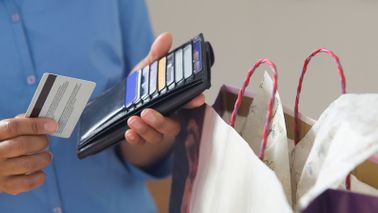 Man with wallet wondering how many credit cards he needs