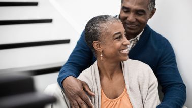 smiling couple sitting on stairs