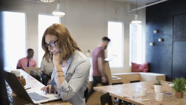 A woman checks her investments on a computer