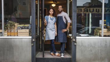 Business owners in doorway. 