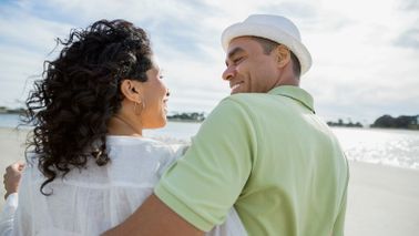 couple walking along the beach dreaming about retirement
