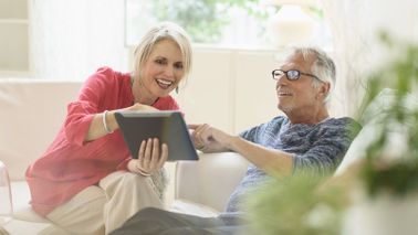 Couple discussing how to help recession proof their retirement savings.