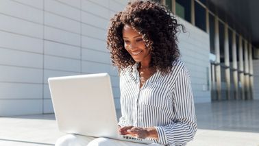 woman reading up on ways to improve her finances in June