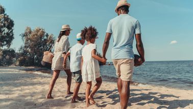 family-holding-hands-on-beach-during-spring-break