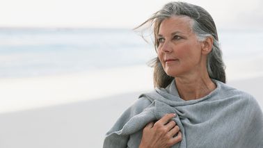woman on beach considering divorce before retirement