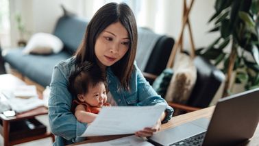 Young mother reviews the financial planning opportunities that the 2024 IRS limit increases may bring her family while caring for her new baby.