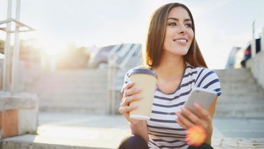 Woman drinking coffee looking to keep her financial new year's resolution