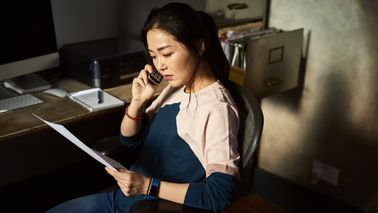 Woman reviewing Northwestern Mutual’s Quick View Tax Guide while discussing her federal income tax rates with her financial advisor.