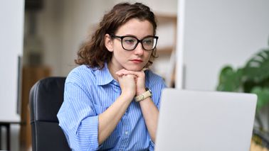 Woman reading Northwestern Mutual’s Weekly Market Commentary.