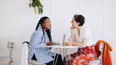 Two women having a conversation over coffee