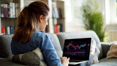 Woman looking at stock performance after reading Northwestern Mutual's Investment Insights piece.