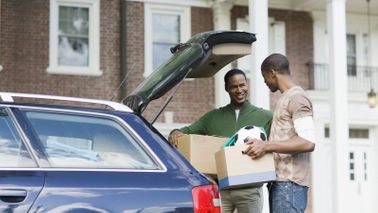 Father helping his son move out of college.
