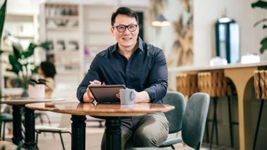 Man at a table reading Northwestern Mutual Asset Allocation Focus