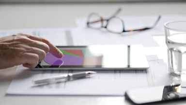 Man on a tablet looking at a high-yield savings account