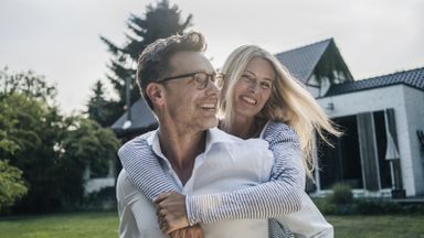 Couple outside their home discussing a spousal lifetime access trust