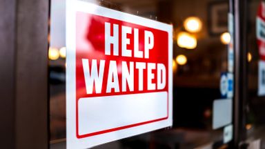 Help wanted sign in store window.