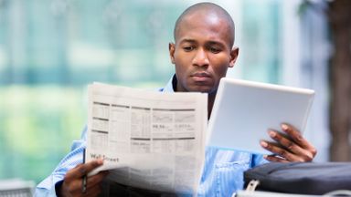 Man looking at the difference between stocks and bonds