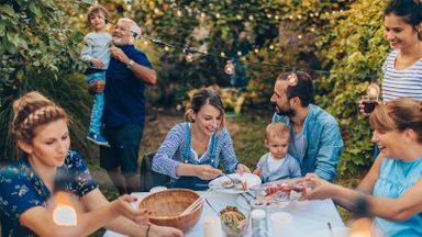 multi-generational family enjoying mid-yard dining experience