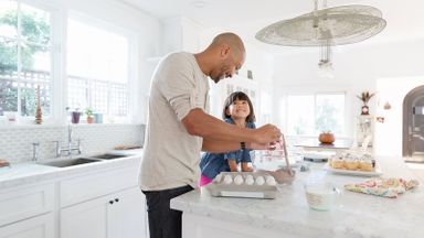 Father and daughter making cupcakes together protected by benefits of whole life insurance
