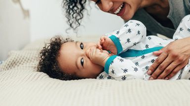 Mom and baby with mom wondering how much it costs to have a baby.