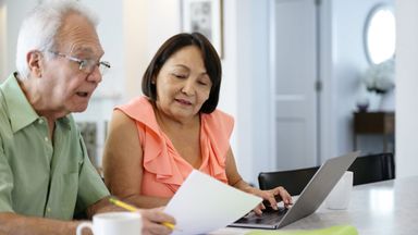 Couple considering the implications of changes to IRS catch-up contribution rules on their retirement savings plan.