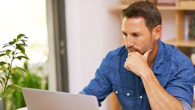 Man thinking about the Northwestern Mutual quarterly market commentary he just finished reading.